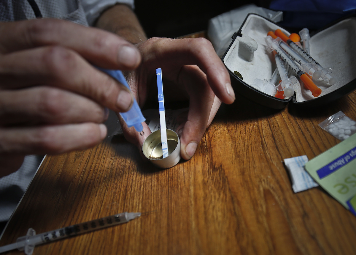 person tests heroin for fentanyl contamination, 8-22-2018