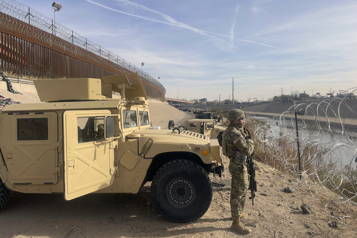 Troops stand guard the along the U.S.-Mexico border in El Paso, Texas, 12-20-2022