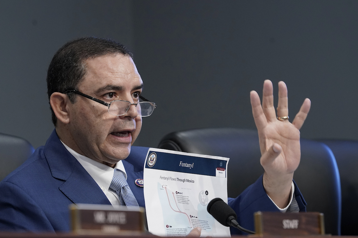 Rep. Cuellar at house hearing holding up piece of paper