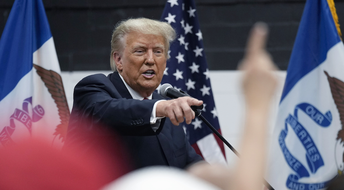 Trump in Iowa speaking into microphone and pointing, 6-1-2023