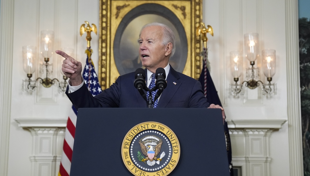 Joe Biden points as he speaks to reporters in Washington, 2-8-2024