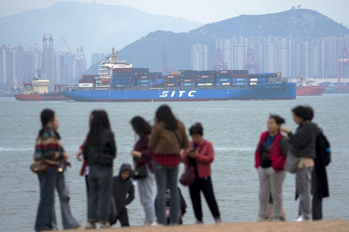 Container ship passes tourists in China