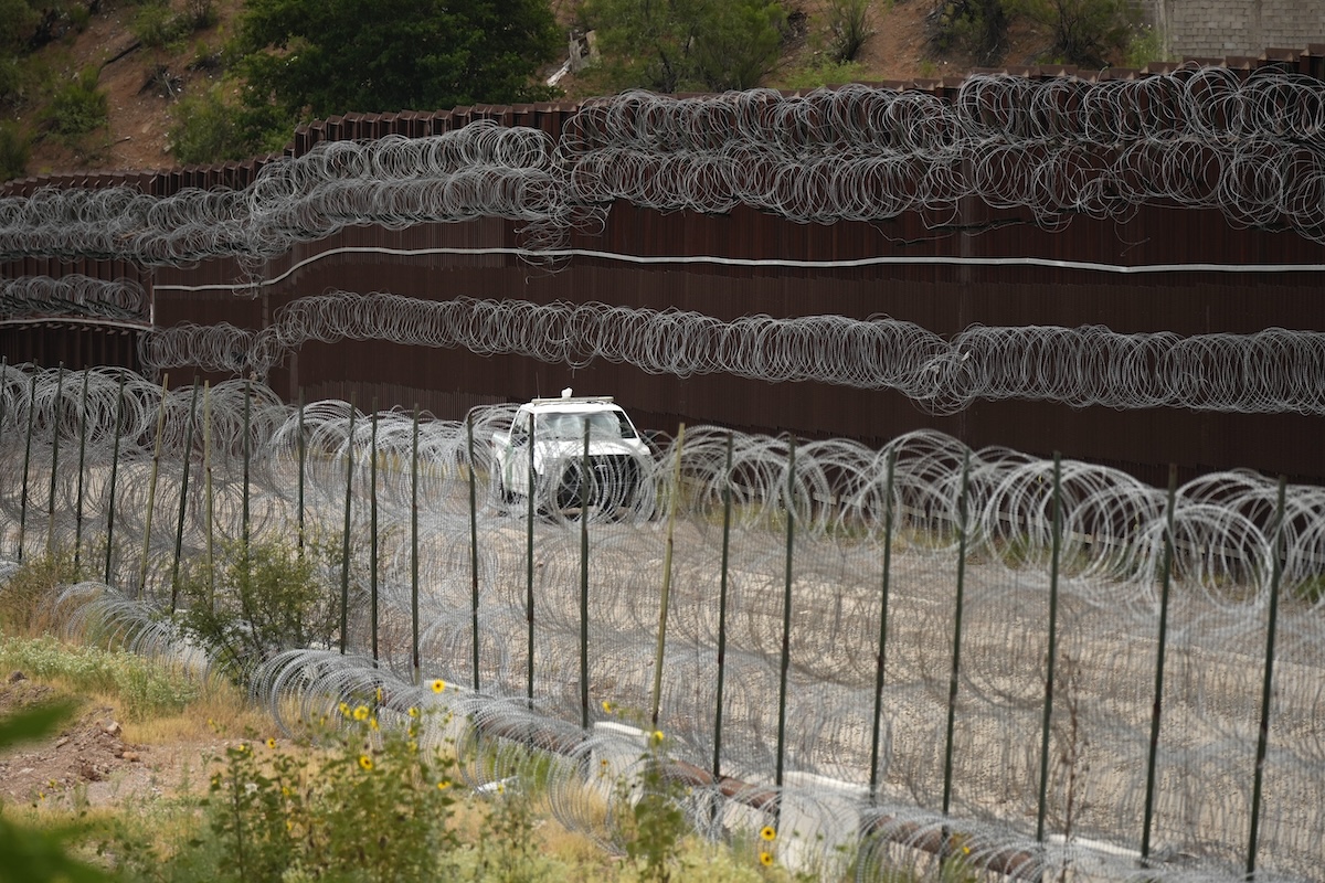 Car driving along border in Nogales for Trump promises