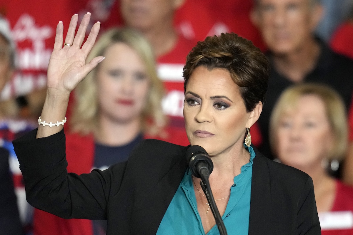 Kari Lake raising her hand