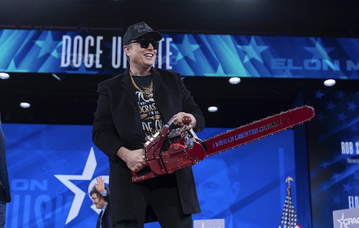 Elon Musk holding chainsaw CPAC 02-20-2025