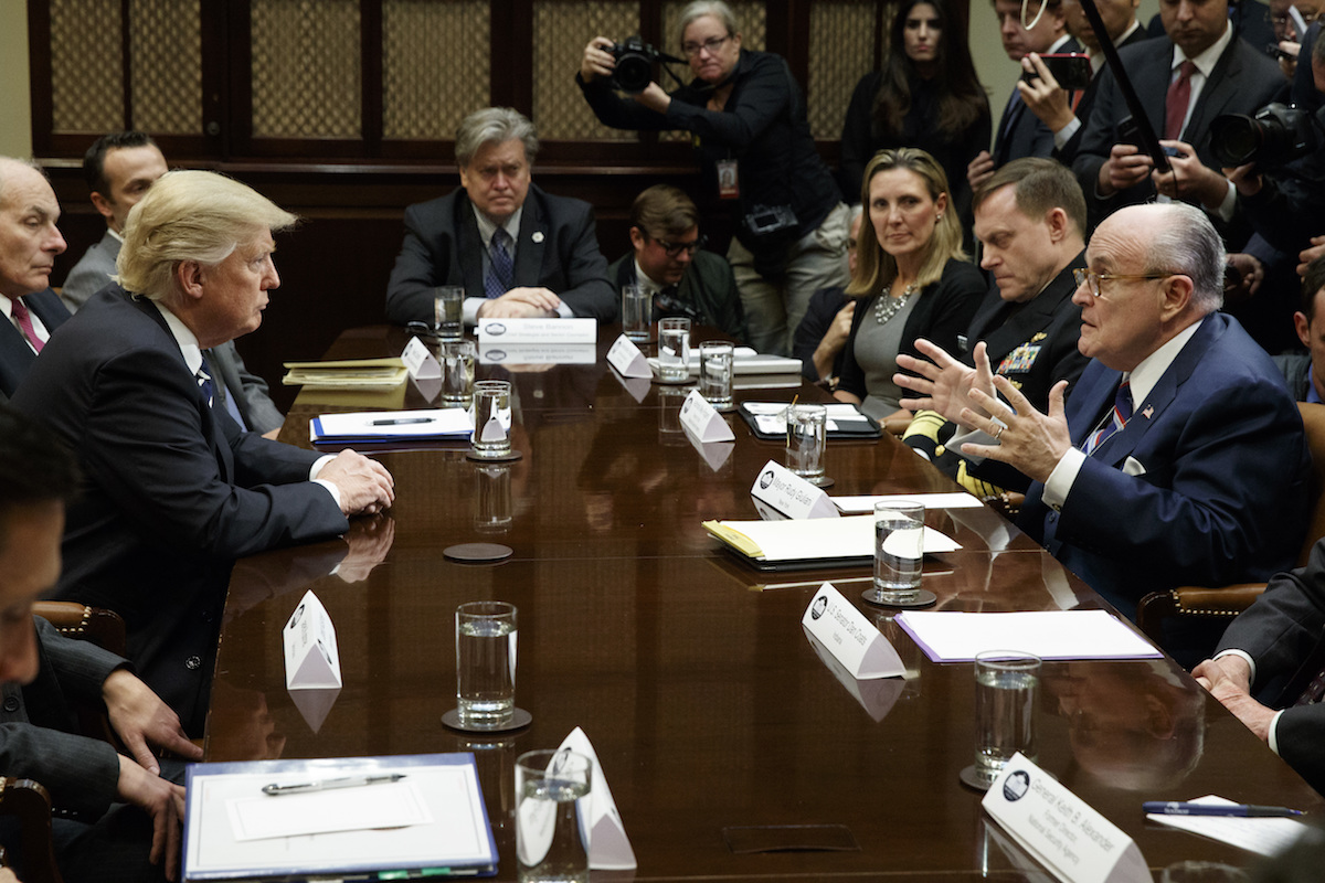 Trump and Rudy Giuliani at boardroom table