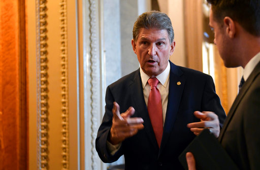 Manchin chatting on Capitol Hill