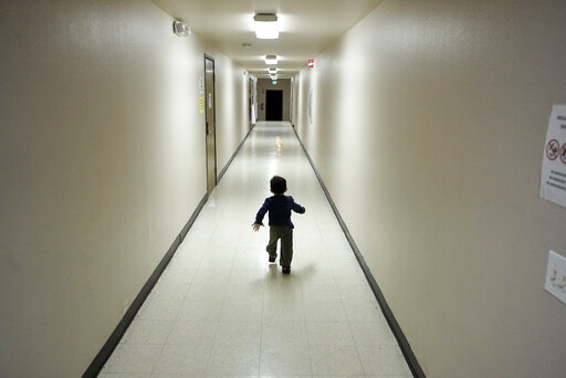 immigrant boy running immigrant shelter hallway