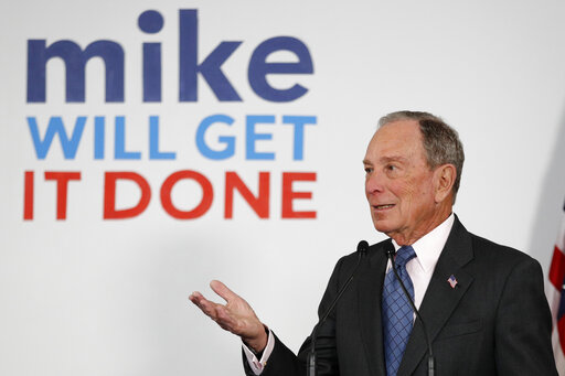 mike bloomberg in front of poster mike will get it done