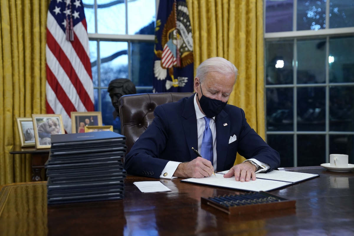 Biden signing EOs on Jan. 20, 2021