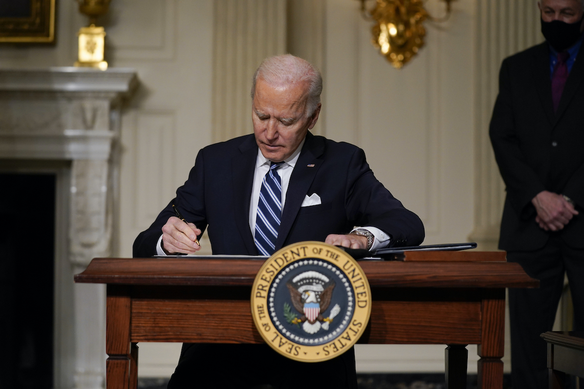 Biden singing a climate change EO on Jan. 27, 2021