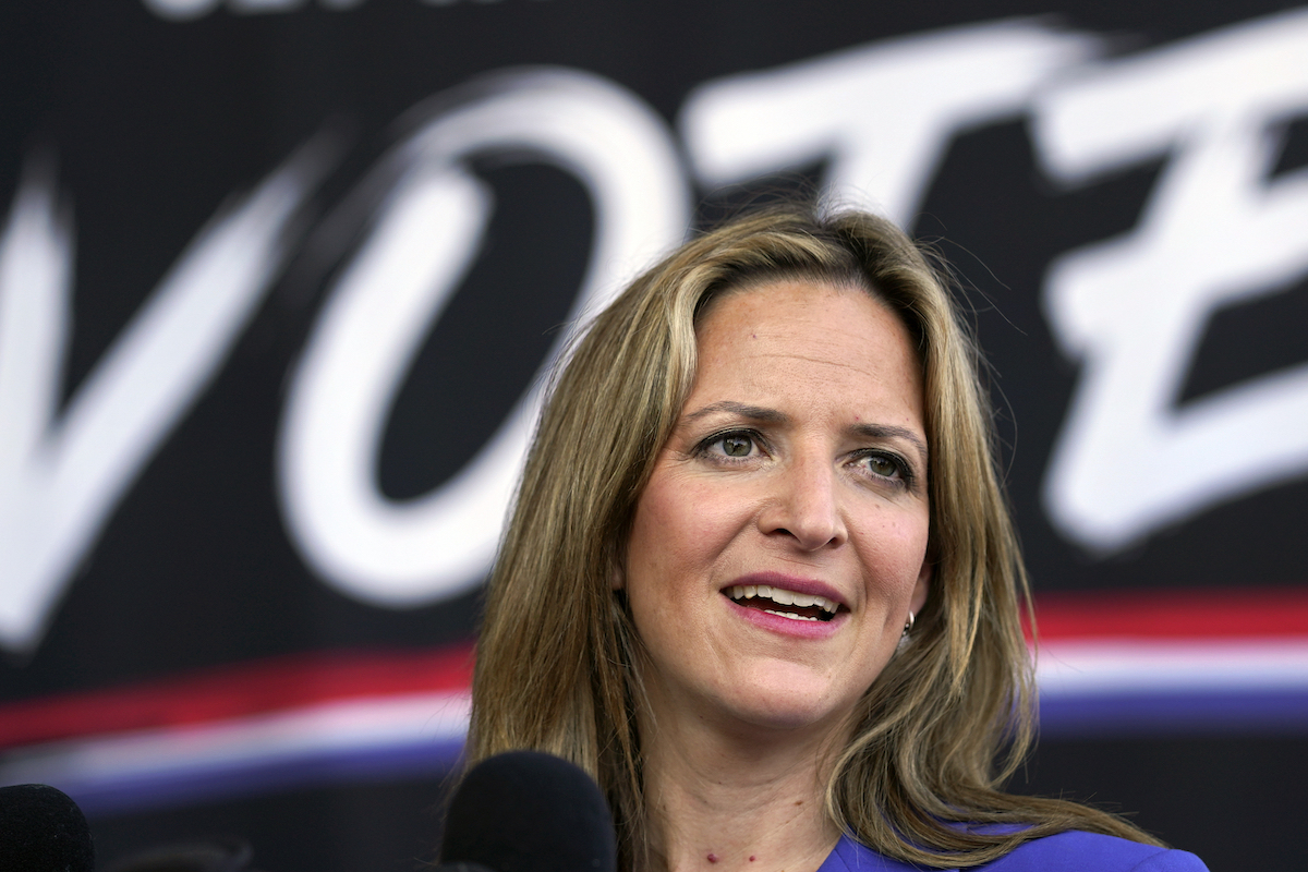 Jocelyn Benson in front of VOTE