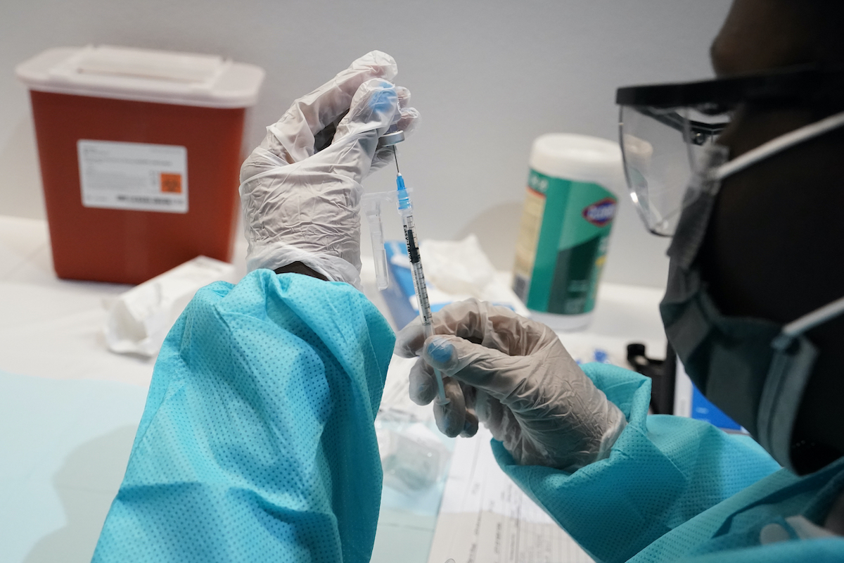 A health care worker fills a syringe with the Pfizer COVID-19 vaccine. July 22, 2021 (AP)