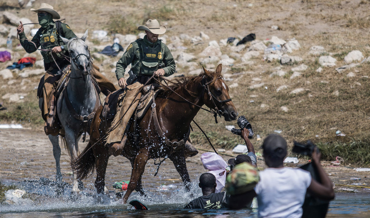 Border Patrol agents on horseback and Haitian migrants in water - CBP investigation