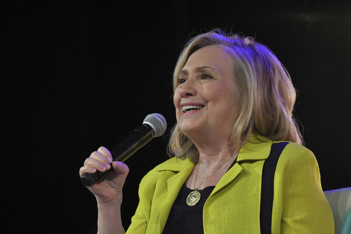 Clinton at New York event July 8, 2022 speaking with mic on stage