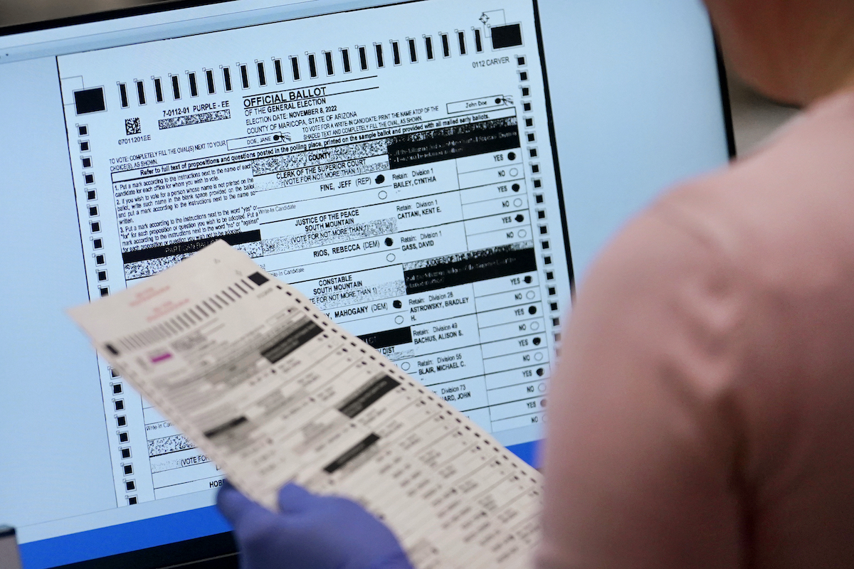 Maricopa election worker verifies ballot on screen 11-10-22
