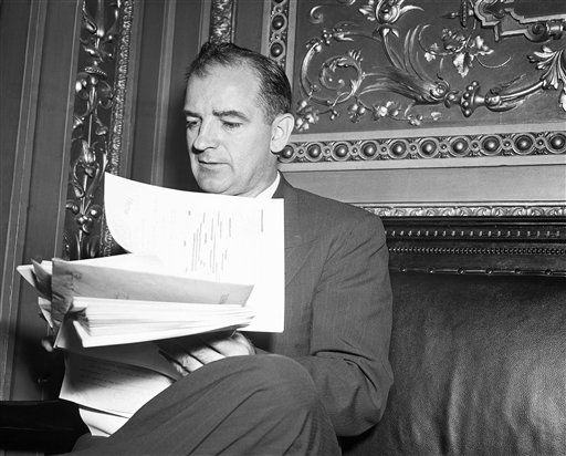 Joe McCarthy holding papers