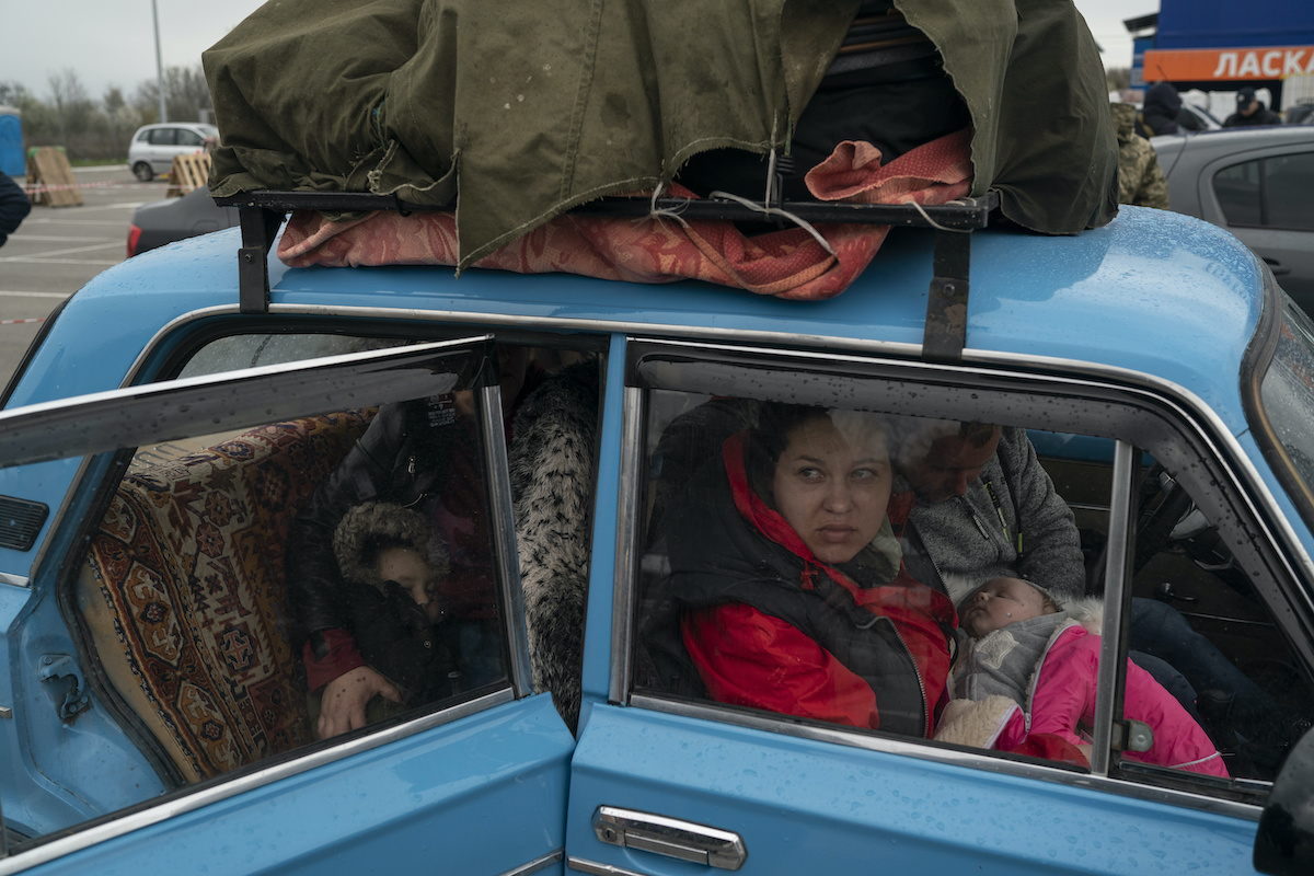 AP Displaced family in car from Mariupol