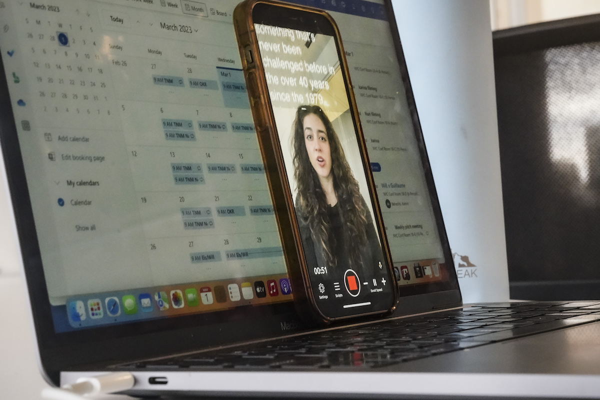 A reporter uses her phone to produce a TikTok March 1, 2023