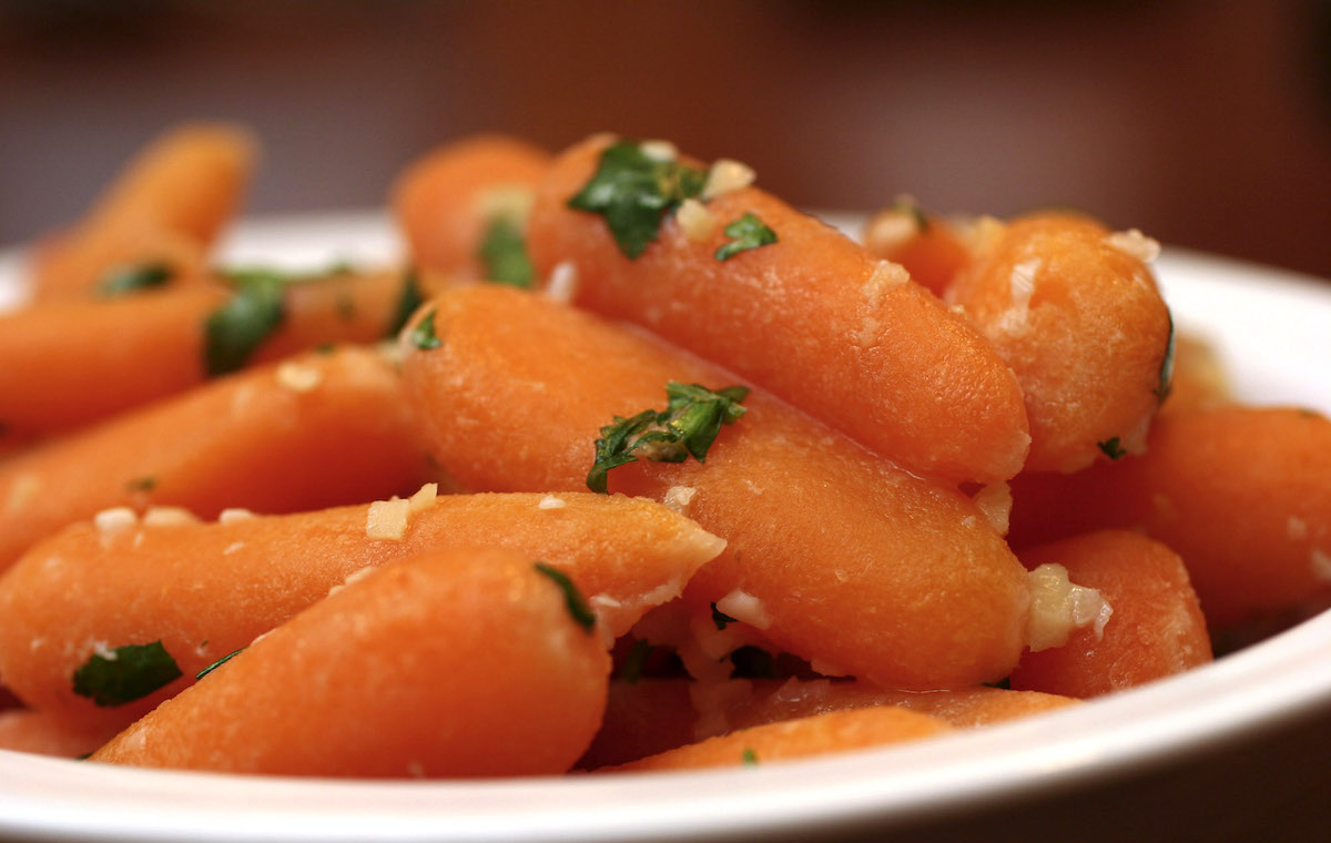 Baby carrots on a plate.