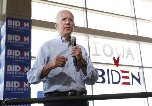Joe Biden in front of Iowa heart Biden sign June 11 2019