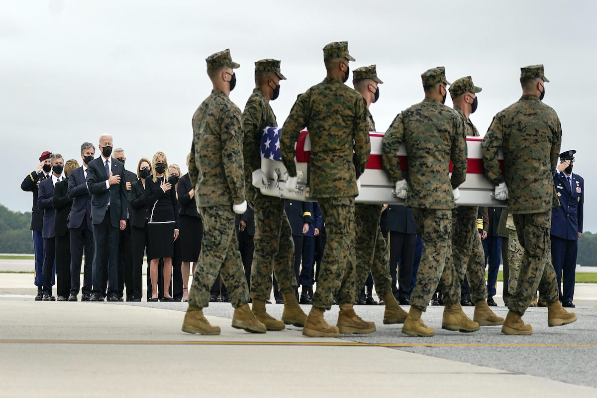 President Joe Biden, first lady Jill Biden, Secretary of State Antony Blinken and others look on as a carry team moves the remains of a fallen U.S. service member at Dover Air Force Base, Aug. 29, 2021. (AP)