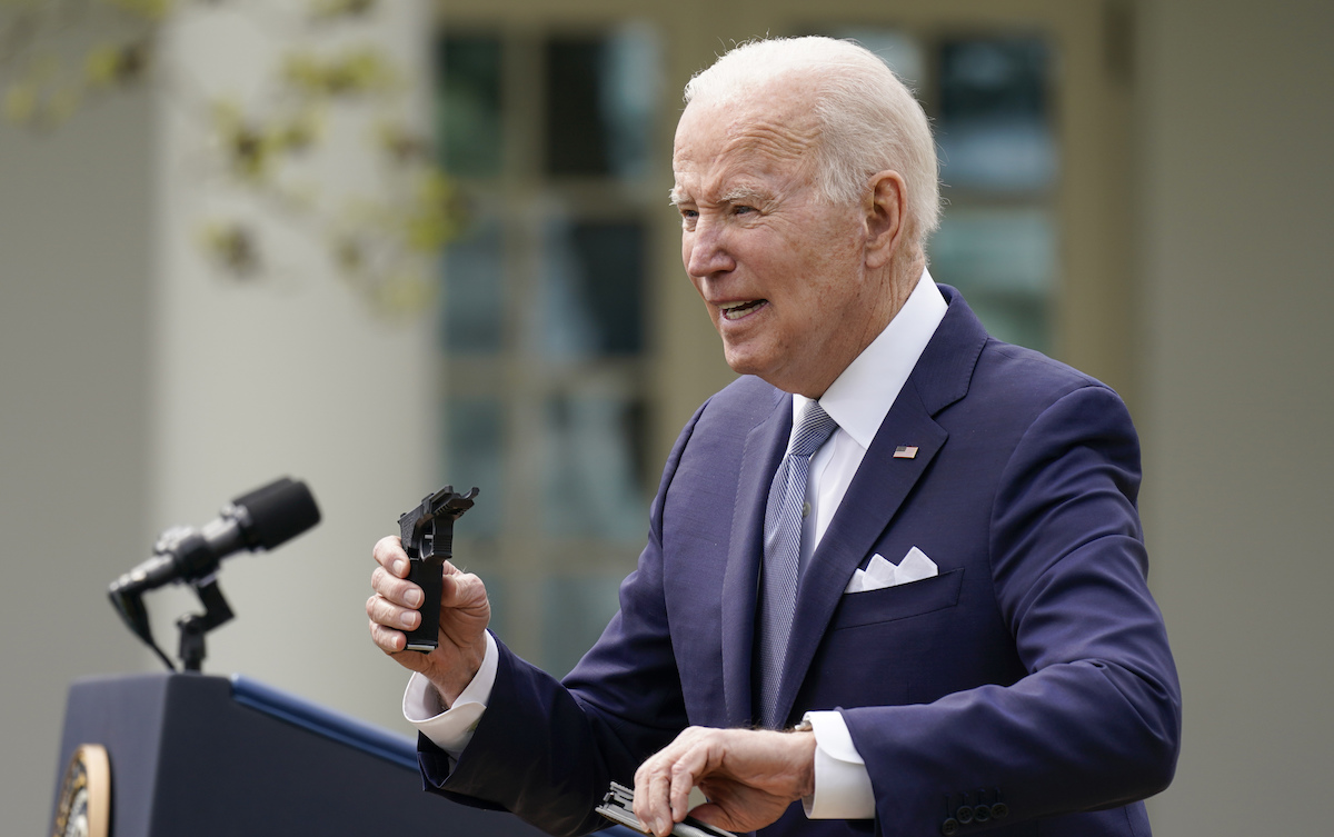 Biden holds pieces of a 9mm pistol
