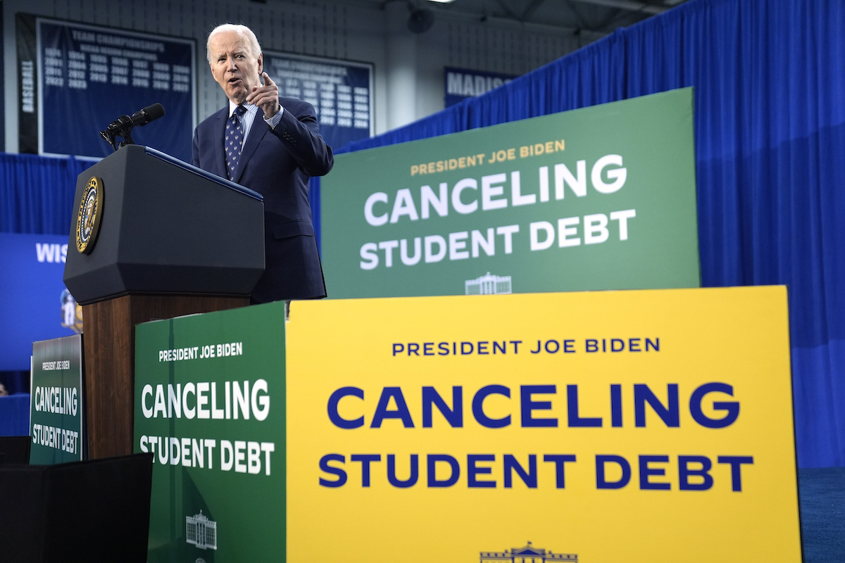 Biden talking around canceling student debt signs for story, 5-27-2024