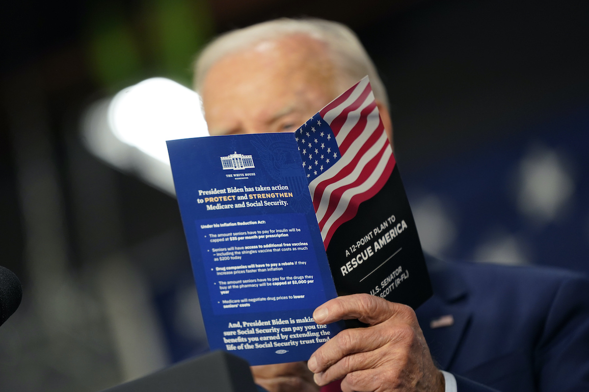 Biden with Rescue America brochure 11-3-22