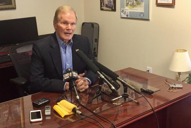 Sen. Bill Nelson sits at a desk