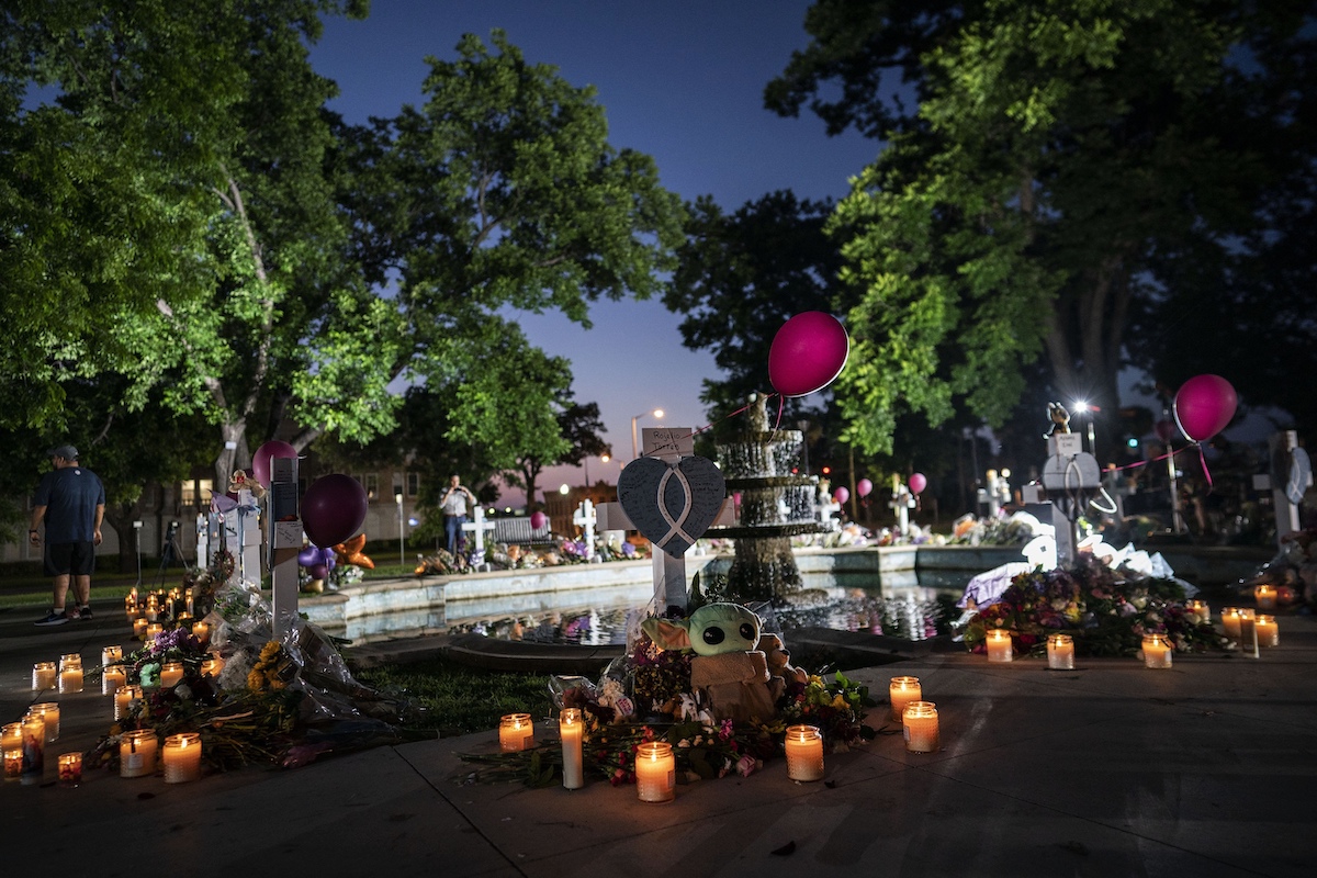 Candles are lit at dawn at a memorial site for Uvalde victims on May 27.