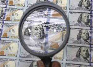 Currency and magnifying glass