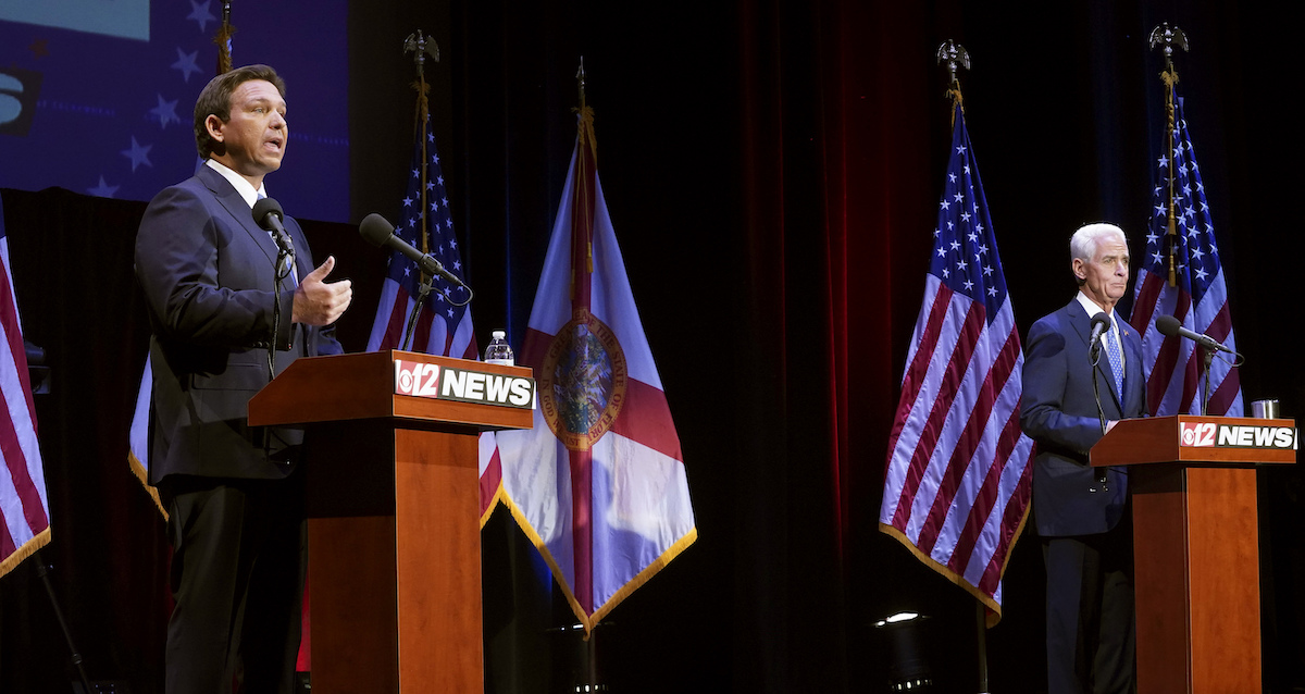 DeSantis and Crist standing at Oct. 24 2022 debate