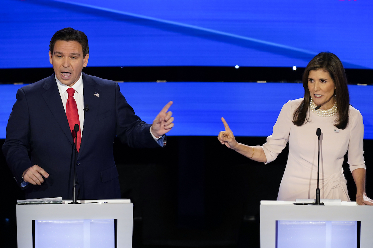 Ron DeSantis and Nikki Haley point at each other on debate stage in Des Moines, Iowa, 1-10-2024