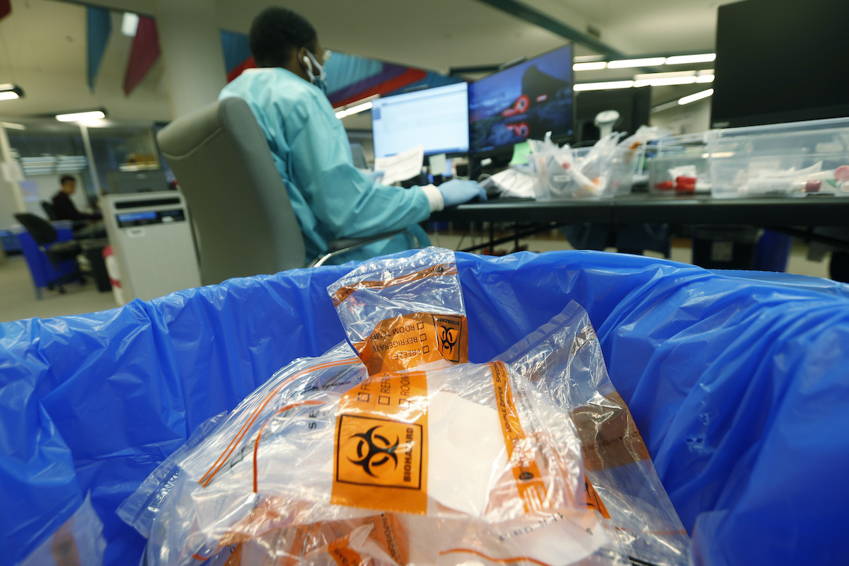 Discarded biohazard bags fill a trash can at Genetworx Clinical Lab in Richmond, Va. April 24, 2020 (AP Photo/Steve Helber)