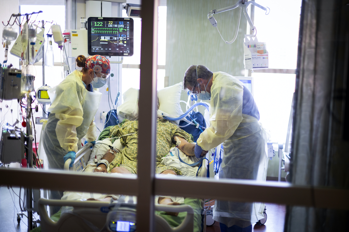 Doctors overlook a COVID-19 patient in the ICU.