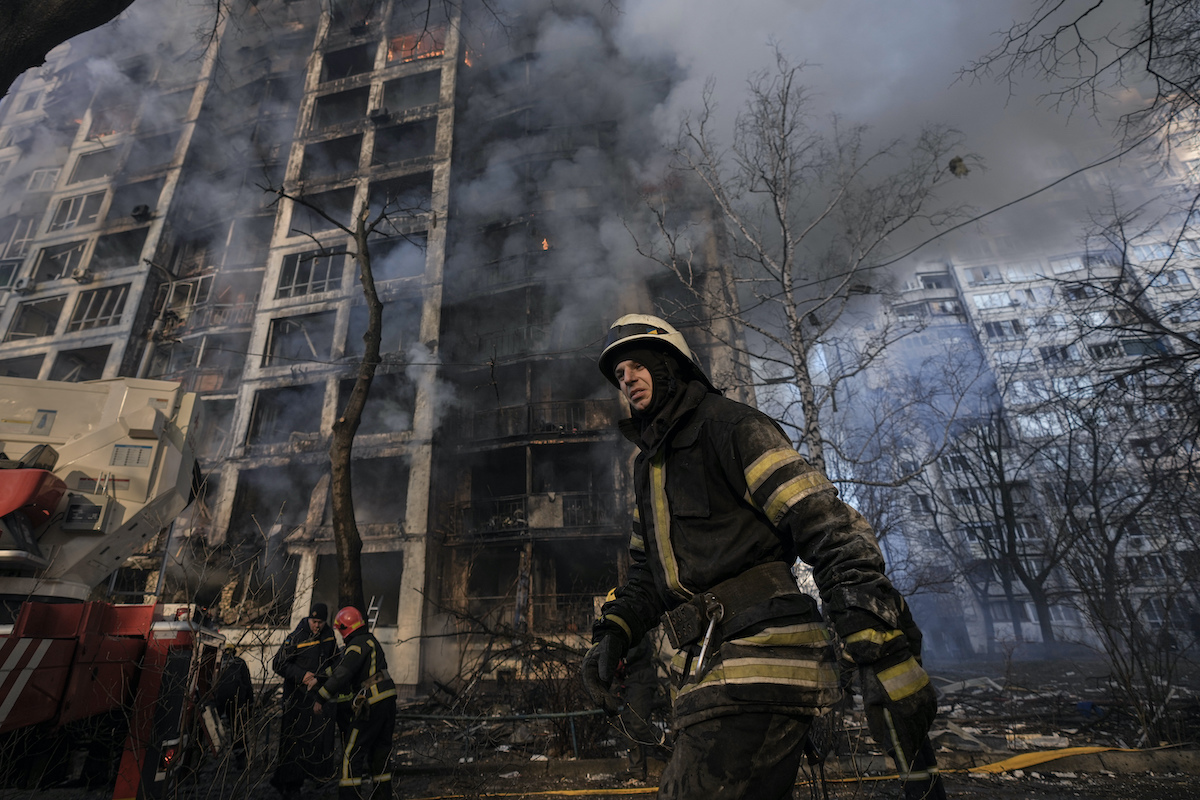 Fire fighter outside a destroyed apartment building in Kyiv 03152022.jpg