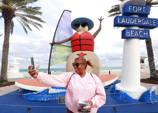 Fort Lauderdale woman on beach by fake snowman