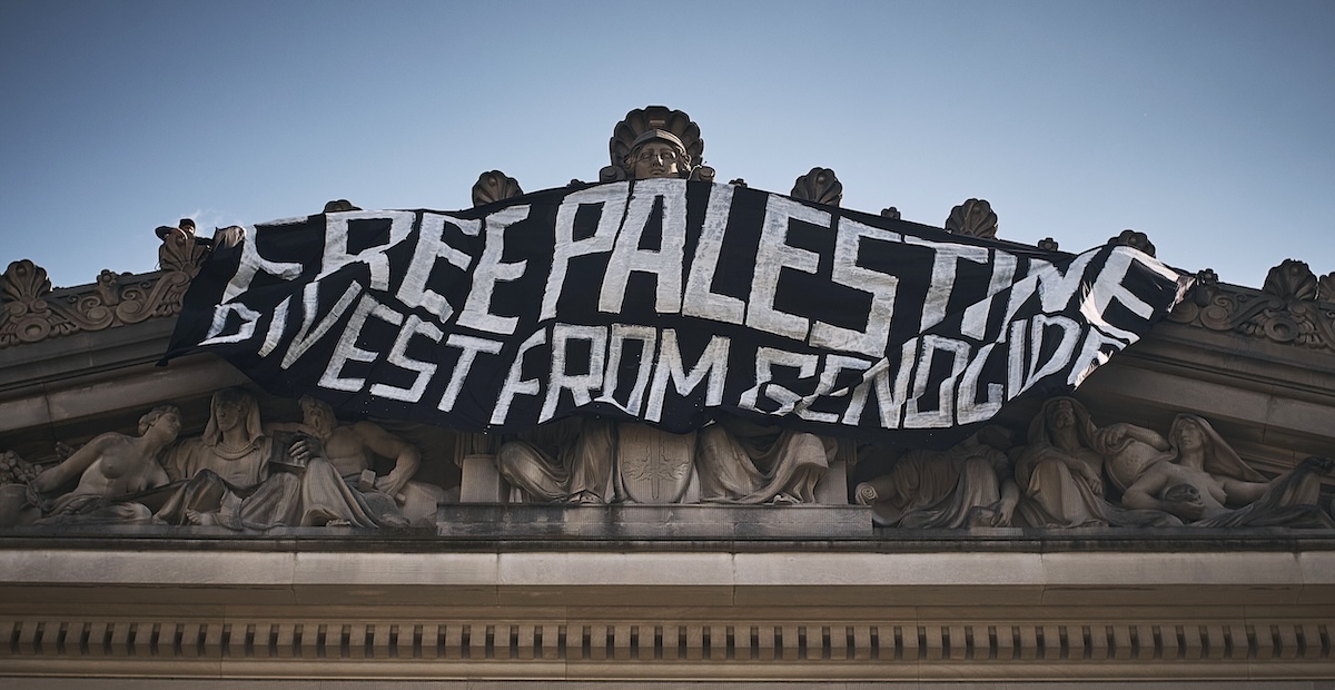 Free Palestine Divest From Genocide banner 05-31-2024