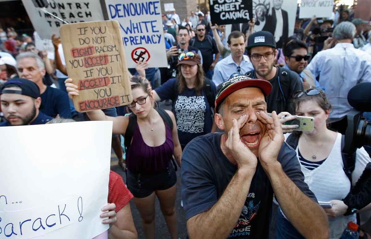 Man shouting in front of crowd at Trump Phoenix rally