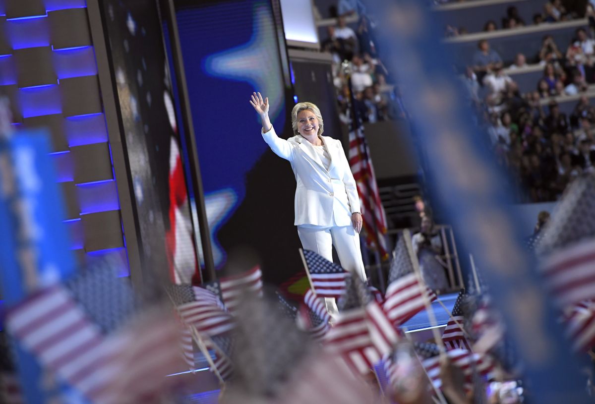 Hillary Clinton waves amidst american flags 2