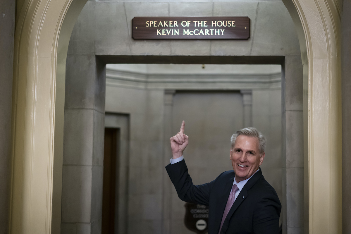 House Speaker Kevin McCarthy points to his nameplate 1-7-23
