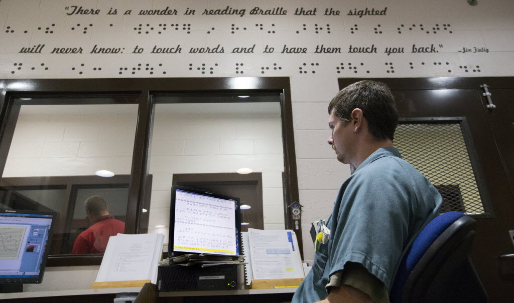 Inmate transcribing braille