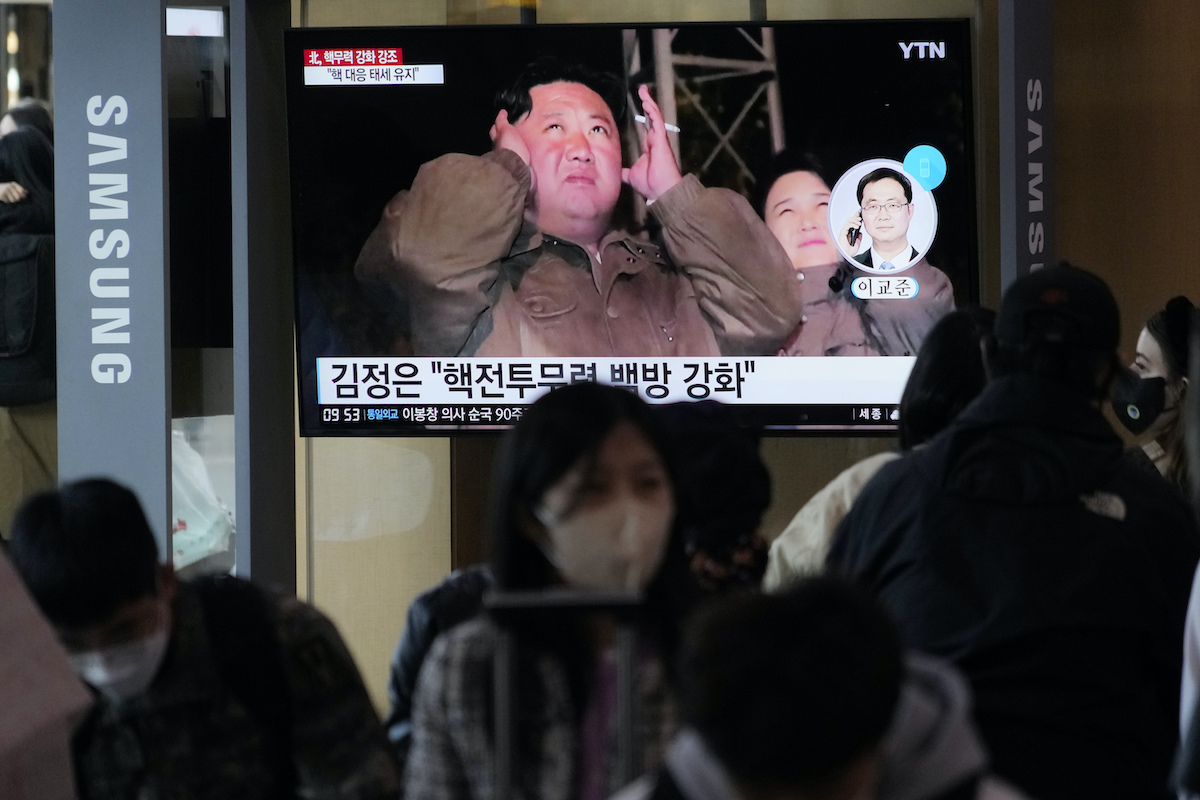 North Korean leader Kim Jong Un and his wife Ri Sol Ju during a news program on South Korea TV