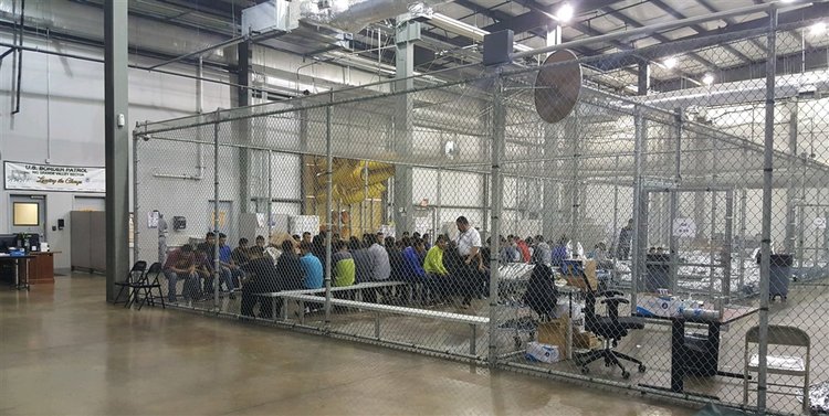 McAllen Texas men in cages on bench June 2018