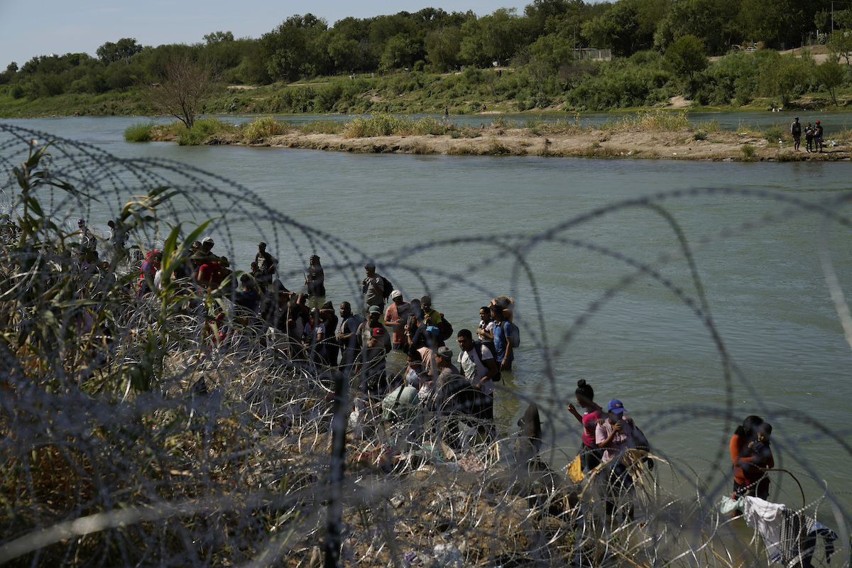 Migrants crossing into the U.S. from Mexico in Eagle Pass, Texas