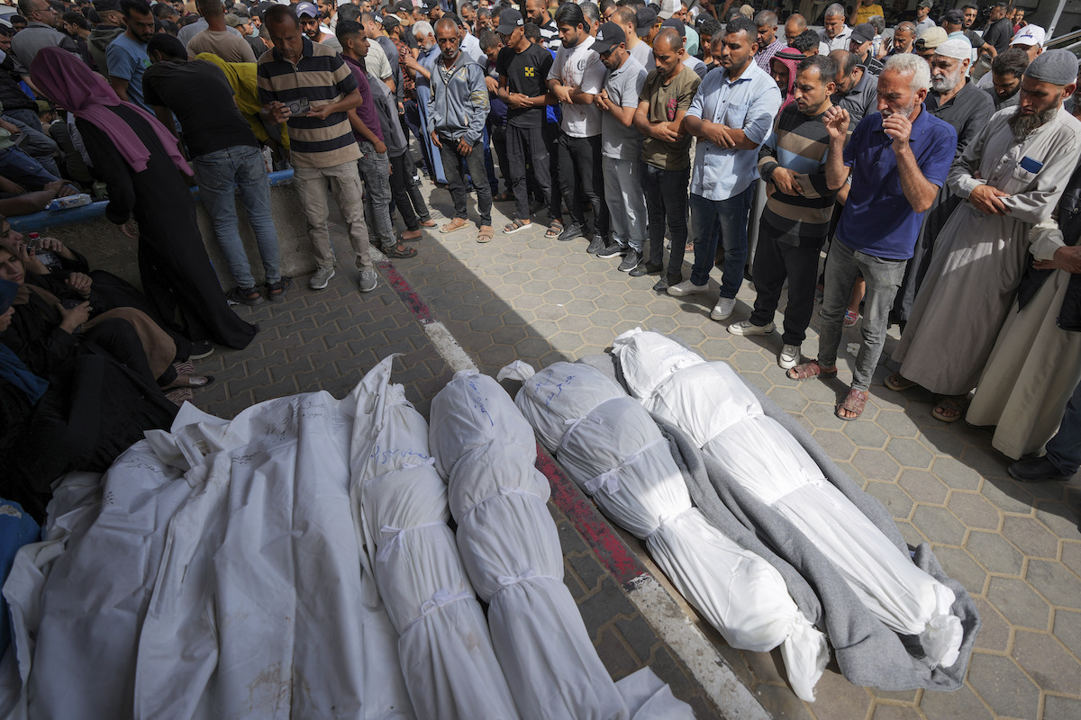Mourners pray over the bodies of Palestinians who were killed in an Israeli strike 05-19-2024