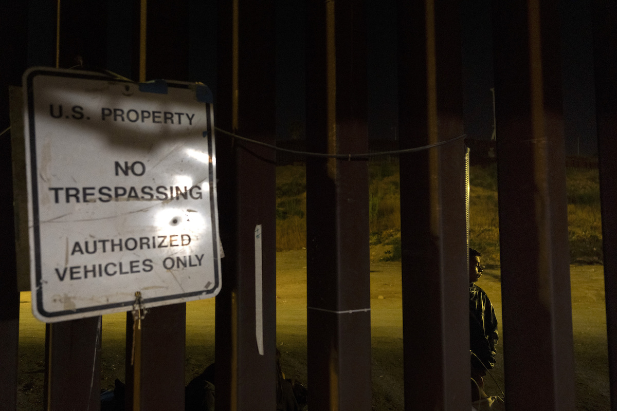 Night photo of trespassing sign at southern border