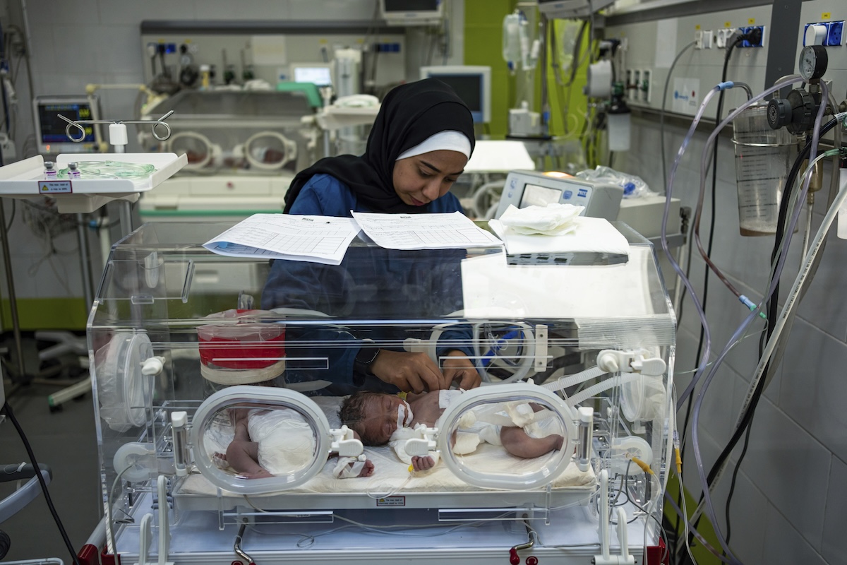 Nurse cares for babies in hosptial in Rafah, Gaza, 3-8-2024