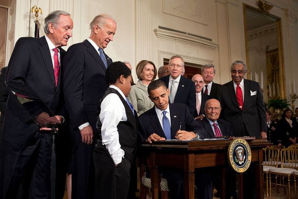 Obama signing Obamacare